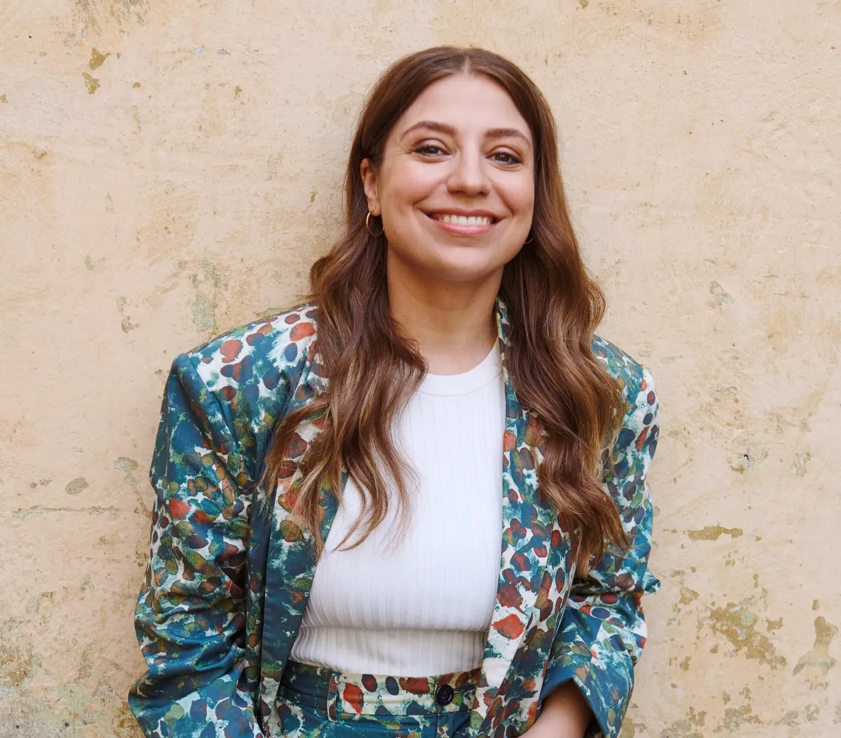Dalia standing in front of a wall