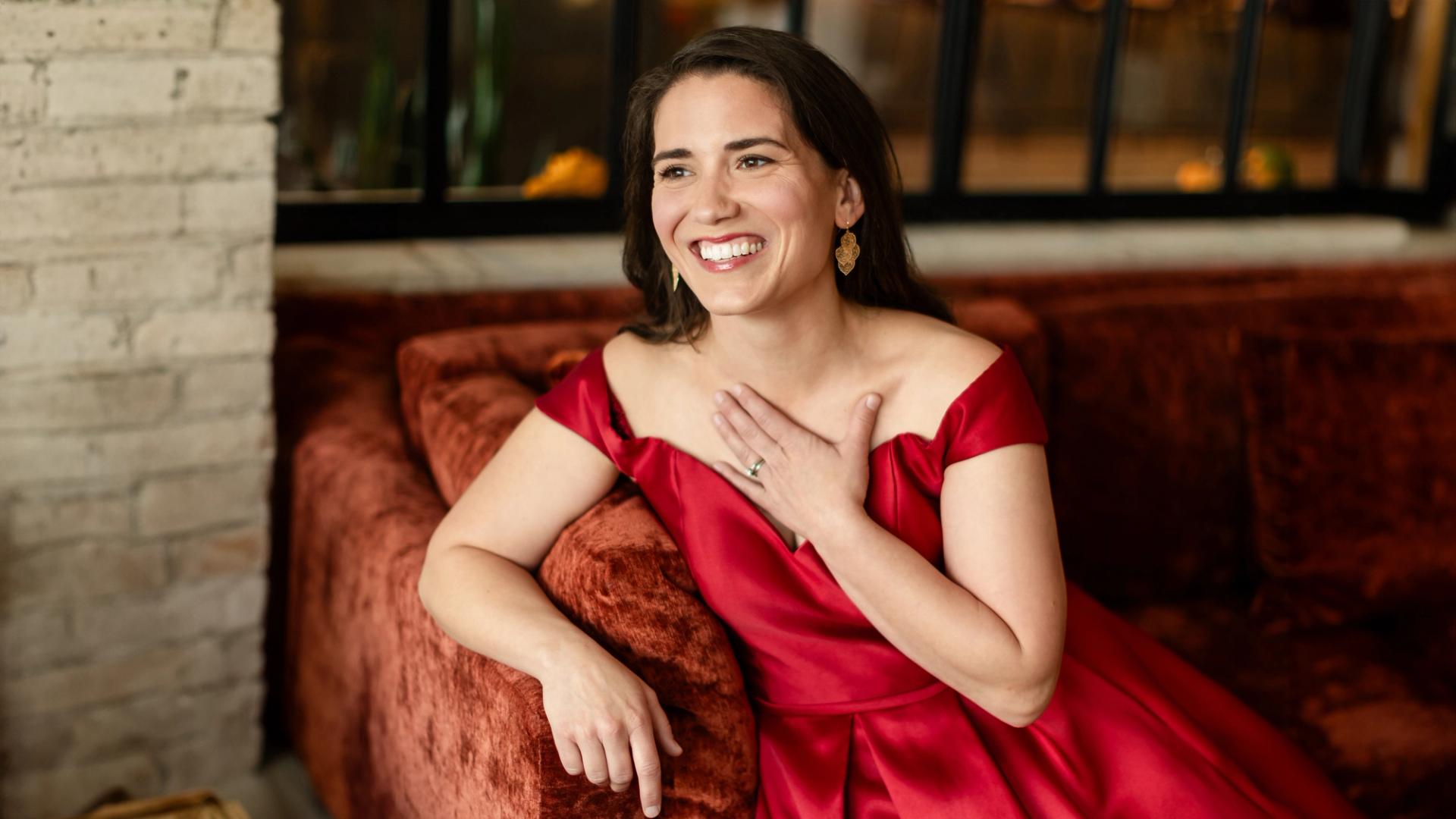 Joelle smiling in a red dress